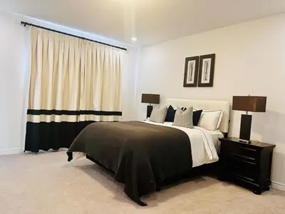 a bedroom with a large bed and a window at Luxury Oakville Home, Hot Tub, Fireplace, New Home in Oakville