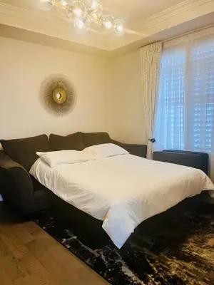 a bedroom with a bed and a large window at Luxury Oakville Home, Hot Tub, Fireplace, New Home in Oakville