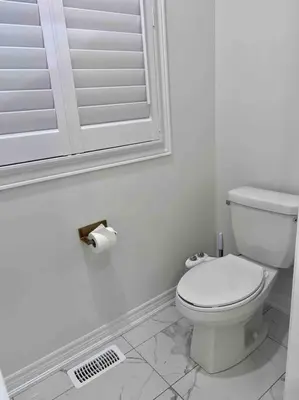 a white bathroom with a toilet and a mirror at Luxury Oakville Home, Hot Tub, Fireplace, New Home in Oakville