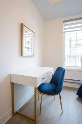 a white desk with a blue chair in a room at Modern 4-Bed Townhome with Cinema & Roof Terrace in Oakville