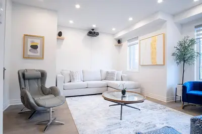 a living room with a couch and a table at Modern 4-Bed Townhome with Cinema & Roof Terrace in Oakville