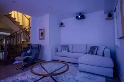 a living room with a couch and a table at Modern 4-Bed Townhome with Cinema & Roof Terrace in Oakville