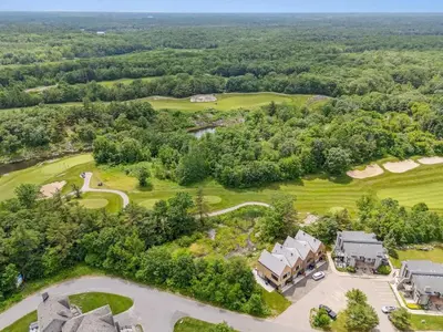 an aerial view of a golf course with a house at Luxury Resort Villa in Muskoka in Gravenhurst