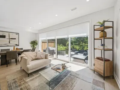 a living room with a couch and a table at Luxury Resort Villa in Muskoka in Gravenhurst