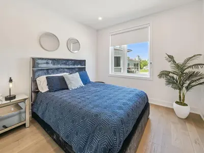 a bedroom with a bed and a potted plant at Luxury Resort Villa in Muskoka in Gravenhurst
