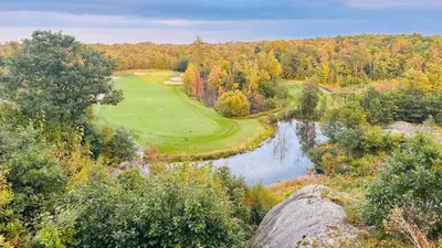 an aerial view of a golf course next to a river at Luxury Resort Villa in Muskoka in Gravenhurst