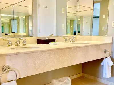a bathroom with two sinks and two mirrors at Hillside Haven: Carriage Club Resort Retreat in Edgar