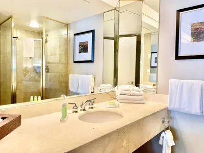 a bathroom with a sink and a large mirror at Hillside Haven: Carriage Club Resort Retreat in Edgar