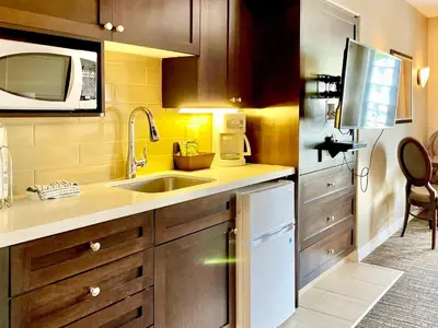 a small kitchen with a sink and a microwave at Hillside Haven: Carriage Club Resort Retreat in Edgar