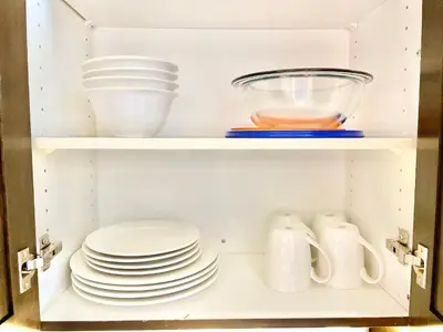 a cabinet filled with plates and bowls and dishes at Hillside Haven: Carriage Club Resort Retreat in Edgar