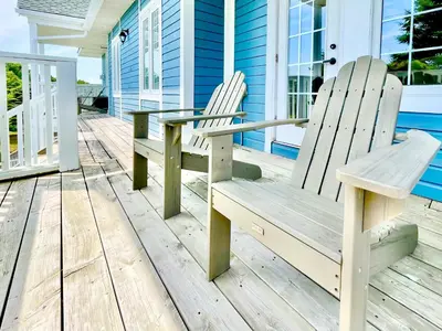 two chairs and a table on the porch of a house at Hillside Haven: Carriage Club Resort Retreat in Edgar