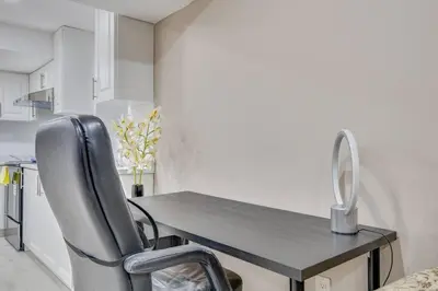 a dining room table with two chairs and a mirror at Hidden Gem: Spacious Basement in Milton