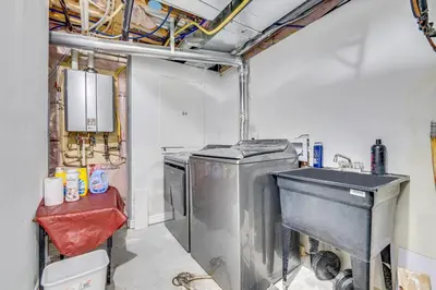 a kitchen with a sink and a washing machine at Hidden Gem: Spacious Basement in Milton