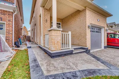 a brick house with a gate and a garage at Hidden Gem: Spacious Basement in Milton