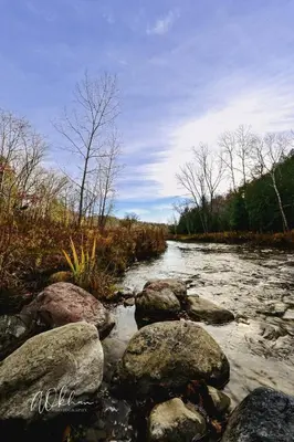 a river with some rocks in the water at Stylish 2BR: w/free parking & streaming! in Pickering