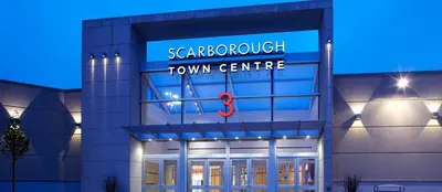 a building with a town centre sign on it at Stylish 2BR: w/free parking & streaming! in Pickering