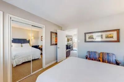 a hotel room with a bed and a mirror at Steps to the Hill 1 Bedroom CraveTV in Blue Mountains