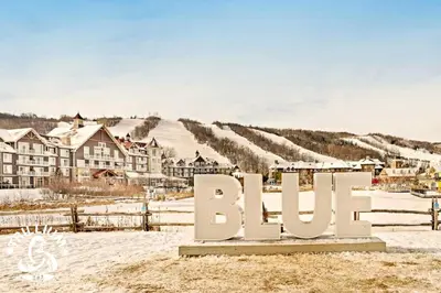a sign in the snow in front of a village at Steps to the Hill 1 Bedroom CraveTV in Blue Mountains