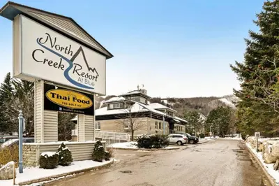 a building with a sign that reads north creek restaurant at Steps to the Hill 1 Bedroom CraveTV in Blue Mountains