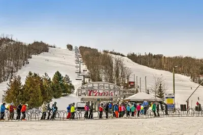 a crowd of people standing in front of a ski lift at Steps to the Hill 1 Bedroom CraveTV in Blue Mountains