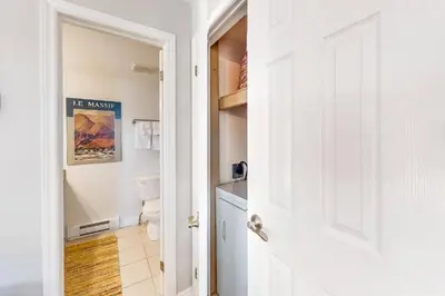 a white bathroom with a toilet and a door at Steps to the Hill 1 Bedroom CraveTV in Blue Mountains