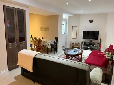 a living room with a couch and a table at 2 bedroom basement with parking in Richmond Hill