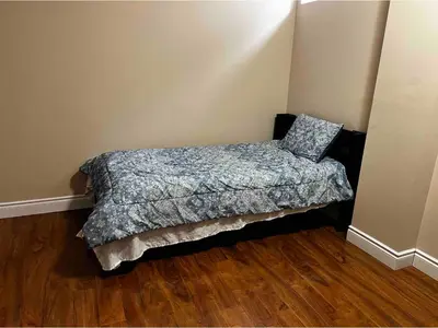 a bedroom with a bed with a pillow on it at 2 bedroom basement with parking in Richmond Hill