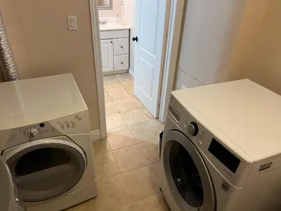 a washer and dryer in a kitchen with a laundry room at 2 bedroom basement with parking in Richmond Hill