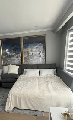a bedroom with a large bed and a couch at Matilda’s Luxury House in Mississauga