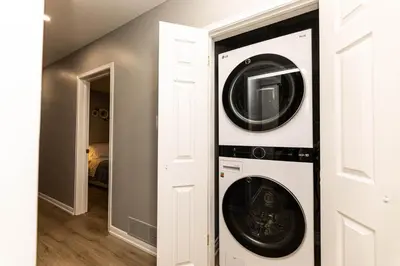 a laundry room with a washer and dryer at Matilda’s Luxury House in Mississauga