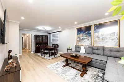 a living room with a couch and a table at Matilda’s Luxury House in Mississauga