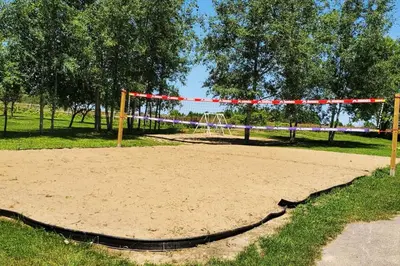 a volleyball court with a net in a park at Serene 4BR house with Hot tub, Lake, Billiards and BBQ in Georgina