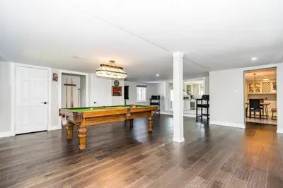 a living room with a pool table in it at Serene 4BR house with Hot tub, Lake, Billiards and BBQ in Georgina