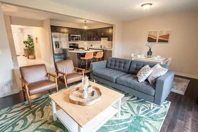 a living room with a couch and a table at 6min To Niagara Falls - 4 Free Parking - Foosball in Niagara Falls