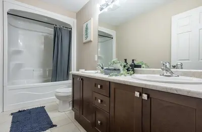 a bathroom with a sink and a toilet and a tub at 6min To Niagara Falls - 4 Free Parking - Foosball in Niagara Falls