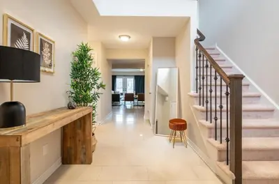 a hallway of a home with a staircase and a stair railing at 6min To Niagara Falls - 4 Free Parking - Foosball in Niagara Falls