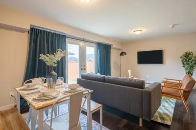 a living room with a couch and a table at 6min To Niagara Falls - 4 Free Parking - Foosball in Niagara Falls