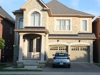 a car parked in front of a house at Stunning Furnished 2 Bedroom 2 Washroom Basement Apartment in Brampton