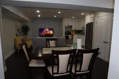 a kitchen and dining room with a table and chairs at Stunning Furnished 2 Bedroom 2 Washroom Basement Apartment in Brampton