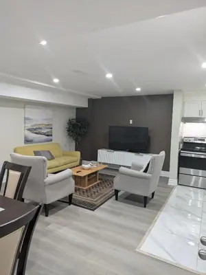 a living room with a couch and a table at Stunning Furnished 2 Bedroom 2 Washroom Basement Apartment in Brampton