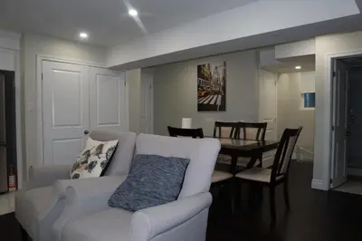 a living room with a white couch and a table at Stunning Furnished 2 Bedroom 2 Washroom Basement Apartment in Brampton