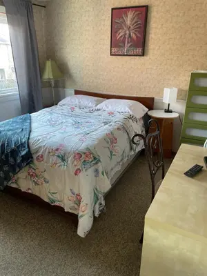 a bedroom with a bed and a table with a desk at Comfortable stay in Milton