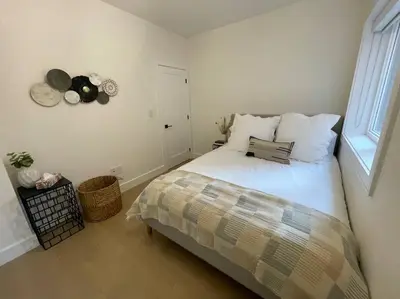 a small bedroom with a bed and a window at Modern Apartment Close To The Beach with Parking in Toronto