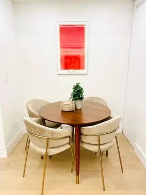 a wooden table with chairs and a potted plant on it at Modern Apartment Close To The Beach with Parking in Toronto
