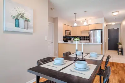 a kitchen and dining room with a table and chairs at RivetStays - The Yonge in Toronto