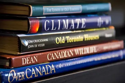 a stack of books stacked on top of each other at Woodbine Warehouse Apartment in Toronto