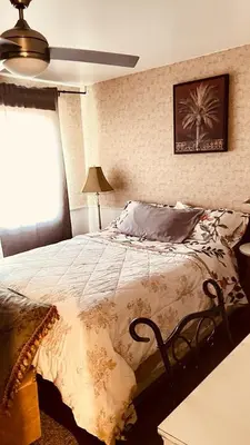 a bedroom with a bed with a comforter on it at Comfortable Stay In Beautiful Home in Milton