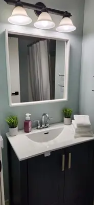 a bathroom with a sink and a mirror at Serenity Place by the Lake in Brighton