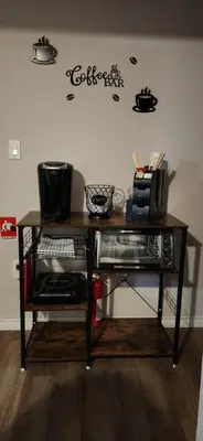a table in a room with a shelf with a microwave at Serenity Place by the Lake in Brighton