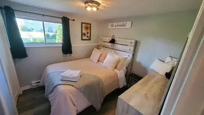 a small bedroom with a bed and a window at Serenity Place by the Lake in Brighton